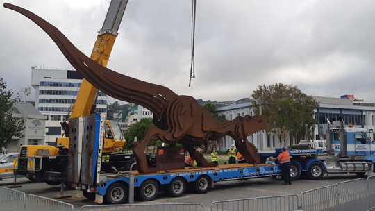 Colin the t-rex being lifted by crane